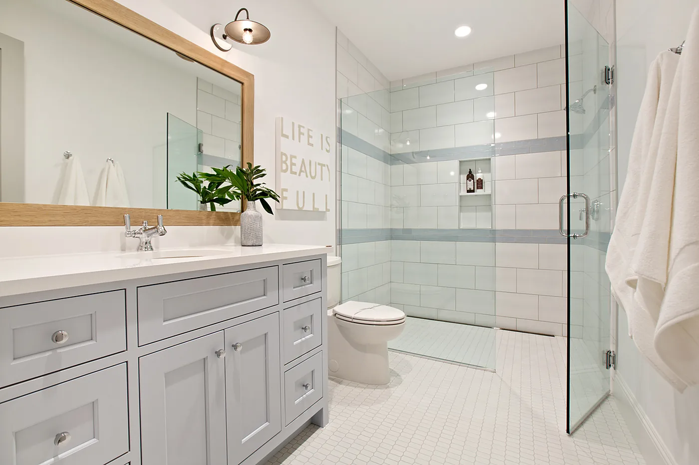 Bathroom renovation with custom cabinetry and glass walk-in shower in North Idaho