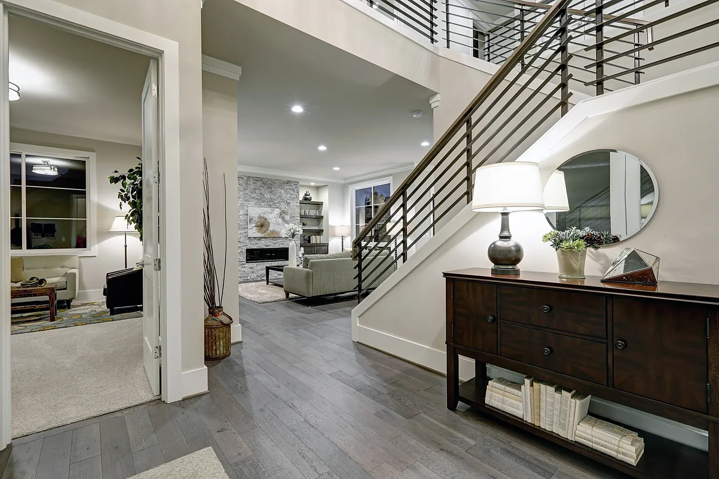 Open-concept living space with custom staircase in a North Idaho custom home