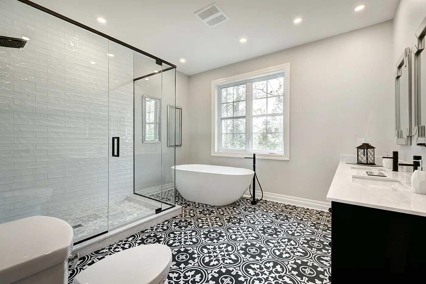Spa-inspired bathroom renovation with soaking tub and custom tile floor in North Idaho