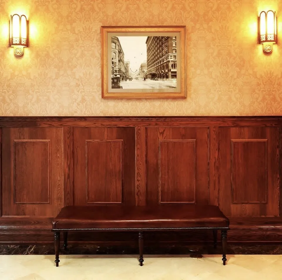 Custom oak raised-panel wainscoting with upholstered bench, architectural woodworking by Rew Construction