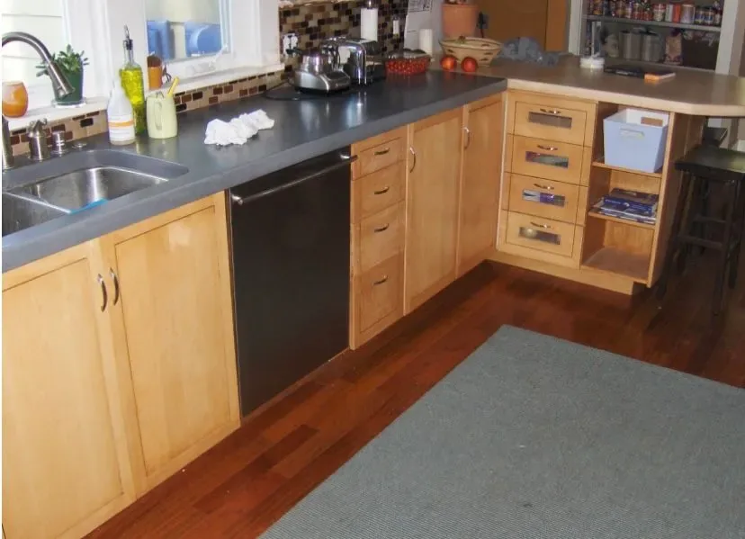 Custom maple kitchen cabinets with tile backsplash and hardwood floors by Rew Construction