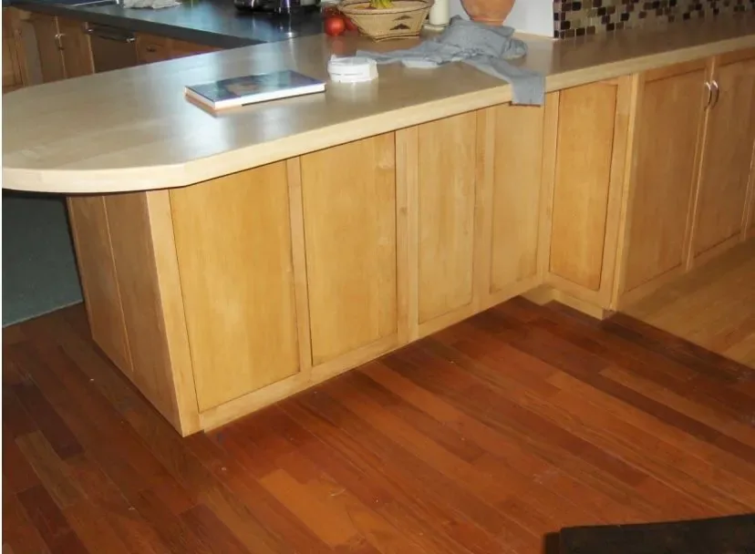 Curved butcher-block breakfast bar on custom maple cabinetry, handcrafted woodworking