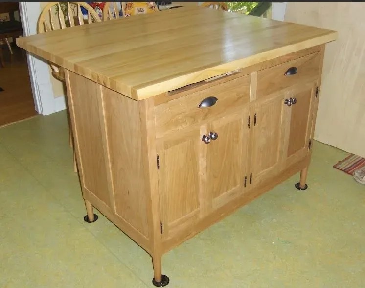 Freestanding kitchen island with butcher block top and custom cabinet doors