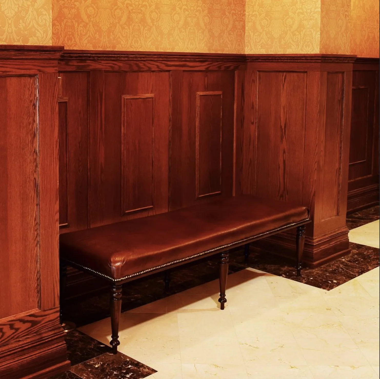 Oak wainscoting panels and leather bench detail, custom millwork by Rew Construction